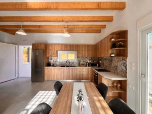 a kitchen with wooden cabinets and a wooden table at Klima Breeze in Klíma