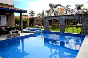 a swimming pool in a yard with a house at Hotel Boutique Rincon Sagrado in Atlixco