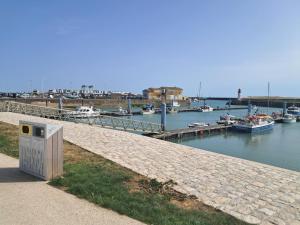 a marina with boats in the water and a dock at La Baie de la tranquilité in Saint-Pierre-dʼOléron