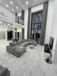 a large living room with a couch and a television at Paradise View Villas in Malindi