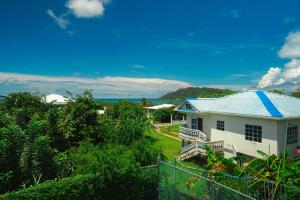 a white house with a blue roof at Old Providence Paradise View in Providencia