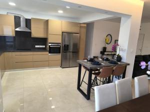 a kitchen with a table and a refrigerator at Eva Luxury Apartment in Paphos