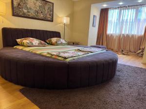 a bedroom with a large bed with a large ottoman at One bedroom king size center in Dnipro