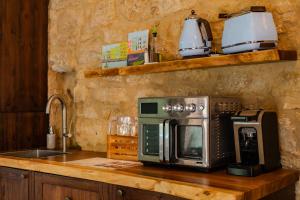 a kitchen counter with a microwave and a sink at Talbot House by Talbot & Bons in Luqa +7 photos