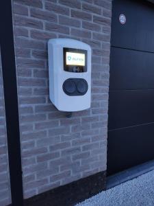 a soap dispenser on the side of a brick wall at 't Ossenhoekske in Sint-Niklaas