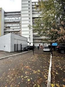 a fence in a parking lot next to a building at One bedroom king size center in Dnipro