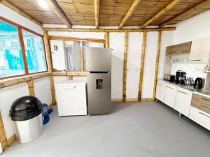 a kitchen with a refrigerator in a room at Surf & Sand Lobitos in Lobitos +30 photos