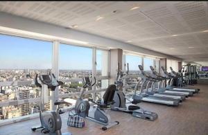 a gym with a bunch of tread machines in a building at Quartier San telmo Piscina climatizada y Spa premium in Buenos Aires