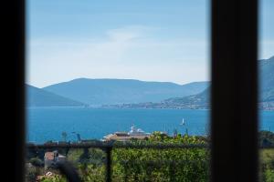 a view of a large body of water from a window at Adriatic Nest Residence in Tivat