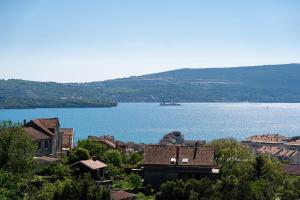 a view of a large body of water with houses at Adriatic Nest Residence in Tivat