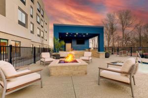 a patio with chairs and a fire pit in front of a building at Hampton Inn & Suites Weatherford, Tx in Weatherford
