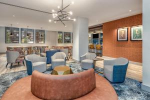 a lobby with chairs and tables and a bar at Hilton Garden Inn- Chicago Central Loop in Chicago