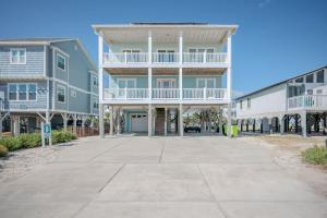 a large apartment building with balconies and a driveway at Wait N Sea by Oak Island Accommodations in Oak Island