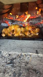 a chicken is cooking in an open oven at Horse Garden in Valea Groşilor +54 photos