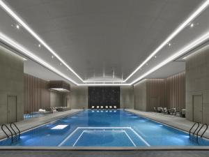 a large swimming pool in a hotel lobby at Hilton Zhuji in Zhuji