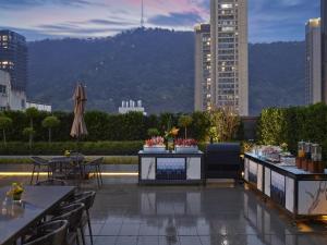 a patio with tables and chairs and a view of a city at Hilton Zhuji in Zhuji
