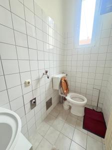 a white bathroom with a toilet and a sink at Beenie 17 in Linz