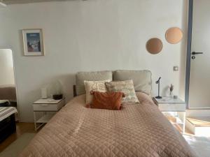 a bedroom with a bed with pillows on it at Good Vibes in Grenoble +1 photo