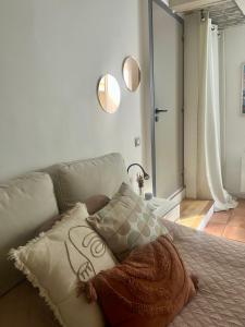 a pillow sitting on a couch in a bedroom at Good Vibes in Grenoble