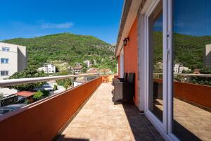 a balcony with a view of a mountain at M Group Studios in Tivat