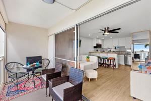 a living room with a dining room and a kitchen at Lahaina Roads 302 in Lahaina