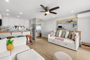 a living room with a couch and a kitchen at Lahaina Roads 302 in Lahaina