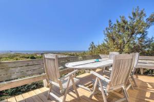 a wooden deck with a table and two chairs at Jonahs Whale by Oak Island Accommodations in Caswell Beach +96 photos