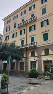a large tan building with windows and a balcony at Contessa Alba in Savona +6 photos