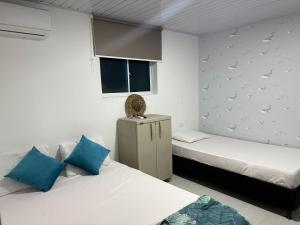a room with two beds and a window at Old Providence Paradise View in Providencia +35 photos