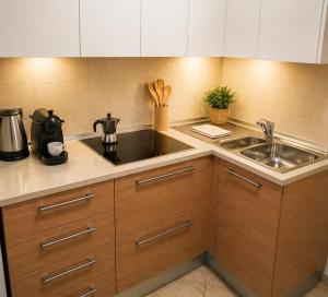 a kitchen with a sink and a counter top at Oxygen Riva del Garda Monolocale con Balcone e Bike Room in Riva del Garda