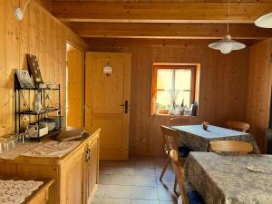 a kitchen with wooden walls and a table and a window at Chalet Dolomiti Trentino in Sant’Orsola