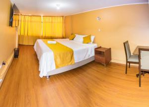 a hotel room with a bed and a desk and a television at Hotel San Lázaro Arequipa - Cochera - Hotel en Arequipa in Arequipa
