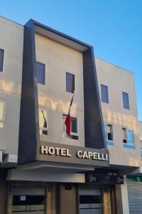 a hotel capelli with a flag on top of it at Hotel Capelli Talca in Talca