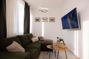 a living room with a green couch and a tv at Lume Capi in Labin