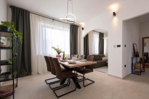 a dining room with a table and chairs and a couch at Lume Capi in Labin