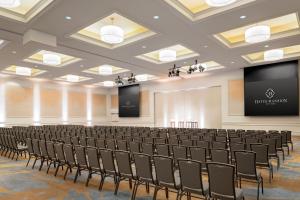 a lecture hall with rows of chairs and a screen at Hayes Mansion San Jose, Curio Collection by Hilton in San Jose +28 photos
