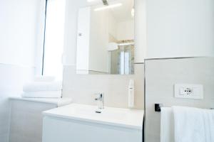a white bathroom with a sink and a mirror at Villa Rossa in Agerola +42 photos