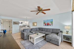 a living room with a couch and a ceiling fan at Sand Between Stays in Orange Beach +32 photos