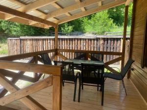 a patio with a table and chairs on a deck at Агрооселя Ростоки in Zhdanivka +17 photos