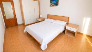 a bedroom with a bed and a table and a mirror at Cala Dei Saraceni in Peschici