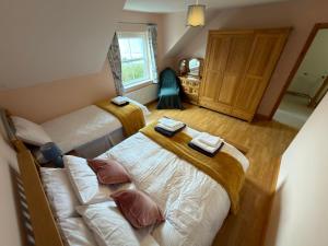 a bedroom with two beds and a couch at 10 Mill Square in Portstewart