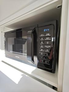 a microwave oven in a kitchen with its door open at Bambou Zen Room in Rang-du-Fliers