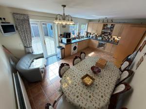 a kitchen with a dining table and a living room at 10 Mill Square in Portstewart