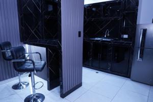 a black room with a chair and a sink at Hotel Gool De Guerron in Quito +29 photos
