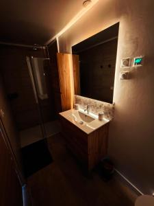 a bathroom with a sink and a mirror at Bambou Zen Room in Rang-du-Fliers +32 photos
