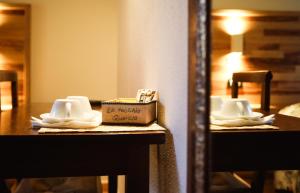 a reflection of a table with dishes and a box on it at Agriturismo La Vecchia Quercia in Montemerano
