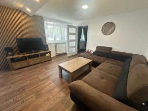 a living room with a couch and a television at Hauspark Residence in Žatec