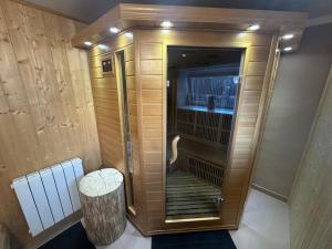 a walk in shower with a bench in a room at Hauspark Residence in Žatec +19 photos