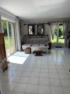 a living room with a couch and a table at Petit coin de paradis Périgourdin in Montrem