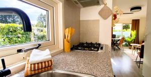 a kitchen with a sink and a window and a stove at Boshuisje Dille te Veluwe in Putten